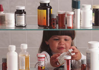 photo of young child looking in medicine cabinet